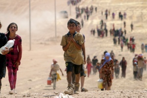 Children from minority Yazidi sect, fleeing violence from forces loyal to Islamic State in Sinjar town, make way towards Syrian border, on outskirts of Sinjar mountain